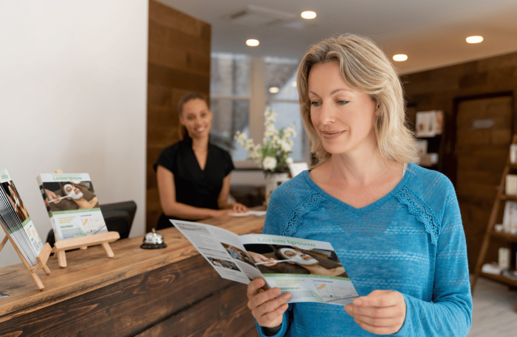 Woman in health clinic looking through brochure - Catdi Houston Printing packages 